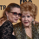 Debbie Reynolds (right), recipient of the Screen Actors Guild Lifetime Achievement Award, and her daughter, Carrie Fisher, pose in the press room during the 21st annual Screen Actors Guild Awards at the Shrine Auditorium in Los Angeles on Jan. 25, 2015.
Ethan Miller/Getty Images
